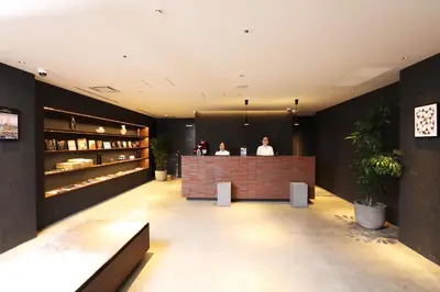 two people sitting at a bar in a lobby at LOF HOTEL Shimbashi in Tokyo