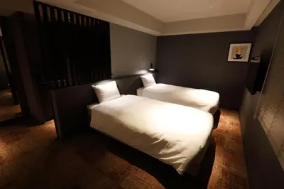a bedroom with two beds in a room at LOF HOTEL Shimbashi in Tokyo
