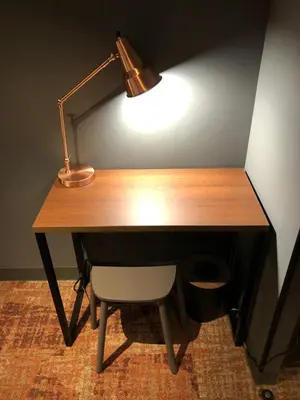 a wooden desk with a lamp and a chair at LOF HOTEL Shimbashi in Tokyo