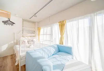 a bedroom with a bed and a blue couch at japan house ebisu in Tokyo