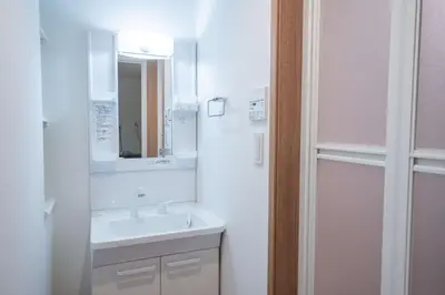 a white bathroom with a sink and a mirror at Noah Ikebukuro - Vacation STAY 11164 in Tokyo