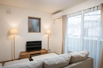 a living room with a couch and a television at Noah Ikebukuro - Vacation STAY 11164 in Tokyo
