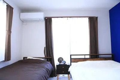 a bedroom with two beds and a window at Wonderful stay TOKYO - Vacation STAY 30862v in Tokyo
