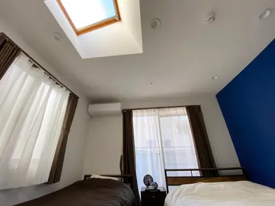 a bedroom with two beds and a window at Wonderful stay TOKYO - Vacation STAY 30862v in Tokyo