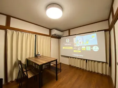 a meeting room with a table and a projector screen at wonderful stay TOKYO Daitabashi - Vacation STAY 31675v in Tokyo