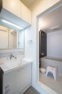 a white bathroom with a sink and a toilet at Serendipity Kinshicho - 7 mins to JR Station - Near Skytree & Foodie hub in Tokyo
