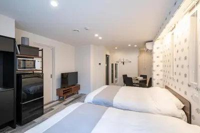 a hotel room with a bed and a television at Serendipity Kinshicho - 7 mins to JR Station - Near Skytree & Foodie hub in Tokyo