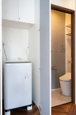 a small bathroom with a refrigerator and a toilet at Serendipity Kinshicho - 7 mins to JR Station - Near Skytree & Foodie hub in Tokyo