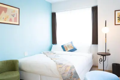 a bedroom with a white bed and a chair at Kiba no Tsuru Carane Hotel - Vacation STAY 09997v in Tokyo