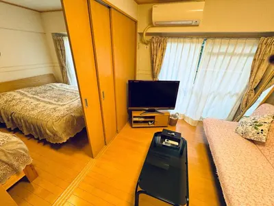 a room with a bedroom with a television and a bed at K&M Heights - Vacation STAY 32224v in Tokyo