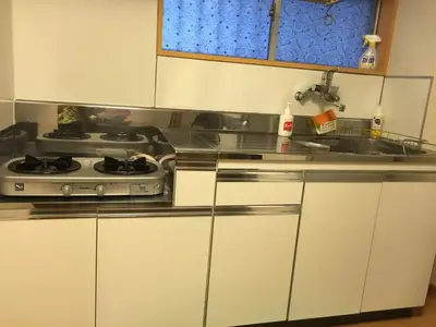 a kitchen with a stove and white cabinets at K&M Heights - Vacation STAY 32224v in Tokyo