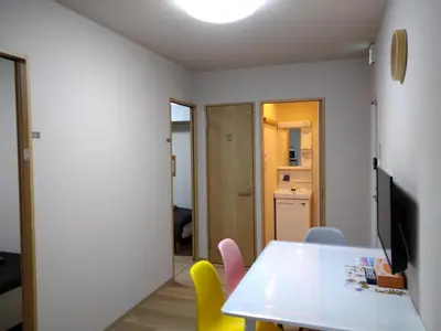 a dining room with a table and yellow chairs at Hitoyado Ryokan Higashiueno - Vacation STAY 35824v in Tokyo