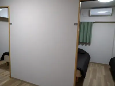 a sliding door in a room with a bedroom at Hitoyado Ryokan Higashiueno - Vacation STAY 35824v in Tokyo