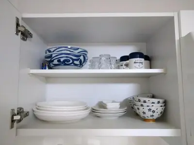 a cupboard filled with plates and bowls in a kitchen at Hitoyado Ryokan Higashiueno - Vacation STAY 35824v in Tokyo