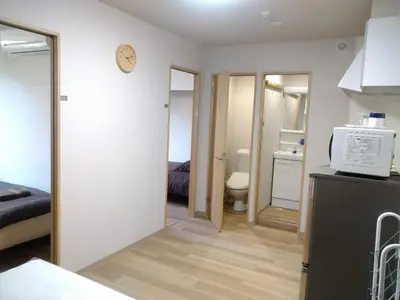 a kitchen with a microwave on top of a refrigerator at Hitoyado Ryokan Higashiueno - Vacation STAY 35824v in Tokyo