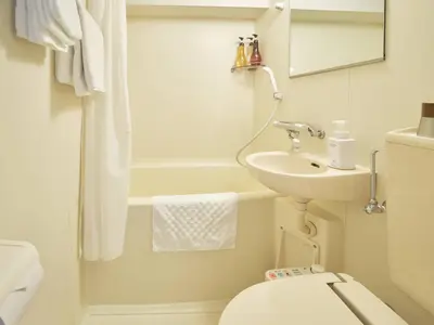 a white bathroom with a sink and a toilet at Pod Select Hotel Shinjuku in Tokyo