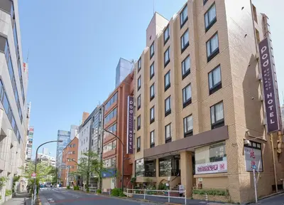 a tall brick building on a city street at Pod Select Hotel Shinjuku in Tokyo