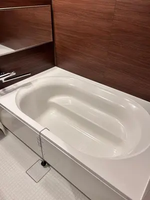 a white bath tub in a bathroom with wood at THREE in Tokyo