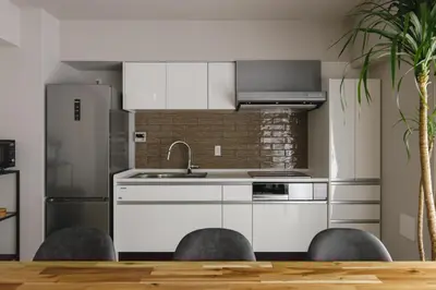 a kitchen with a sink and a refrigerator at THREE in Tokyo