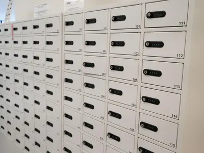 a wall of lockers in a locker room at Rembrandt Cabin Shinjuku Shin-Okubo in Tokyo