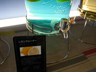 a glass bottle of lemonade with a sign next to it at Rembrandt Cabin Shinjuku Shin-Okubo in Tokyo