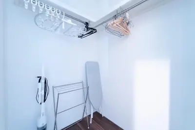a kitchen with white walls and a shelf with glasses at Shibuya-ku - House - Vacation STAY 11243 in Tokyo