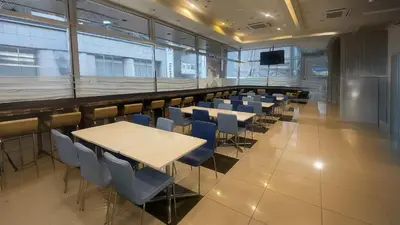 a conference room with tables and chairs and a tv at Toyoko Inn Tokyo Asakusa Kuramae No.2 in Tokyo