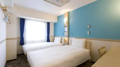 a hotel room with two beds and a window at Toyoko Inn Tokyo Asakusa Kuramae No.2 in Tokyo