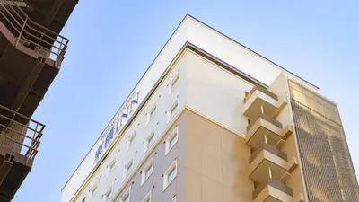 a building in front of a blue sky at Toyoko Inn Tokyo Asakusa Kuramae No.2 in Tokyo