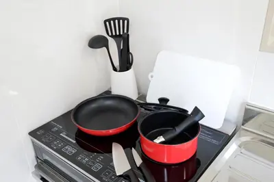 two pots and pans sitting on top of a stove at Oji Natural Cosy House in Tokyo