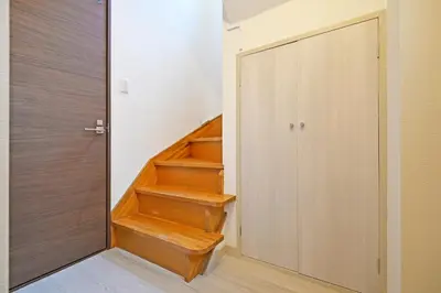 a staircase with wooden steps next to a door at Oji Natural Cosy House in Tokyo