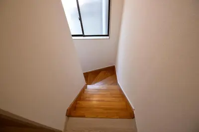 an empty hallway with a window and a wooden floor at Oji Natural Cosy House in Tokyo
