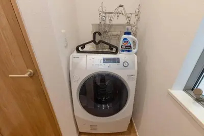 a washing machine in a corner of a room at Sky Tree house in Tokyo