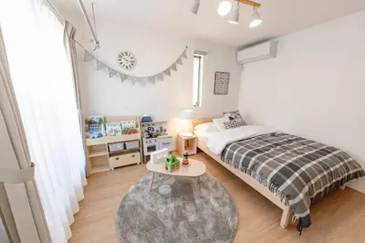 a small bedroom with a bed and a table at Sky Tree house in Tokyo