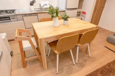 a wooden table and chairs in a kitchen at Sky Tree house in Tokyo