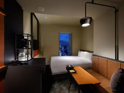 a hotel room with a bed and a table at Shinjuku Granbell Hotel in Tokyo