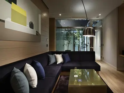 a living room with a black couch and a glass table at Shinjuku Granbell Hotel in Tokyo