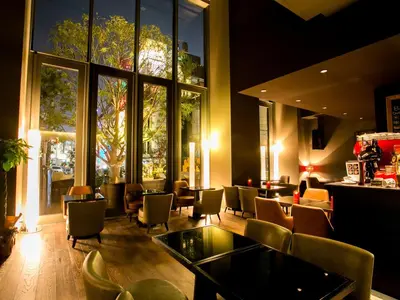 a restaurant with chairs and tables and a large window at Shinjuku Granbell Hotel in Tokyo