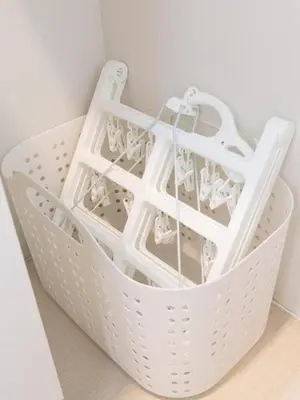 a white laundry basket sitting on top of a floor at \u30e9\u30d5\u30a3\u30c3\u30c8\u4e21\u56fd in Tokyo