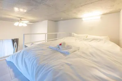 a white bed with a stuffed animal on top of it at \u30e9\u30d5\u30a3\u30c3\u30c8\u4e21\u56fd in Tokyo