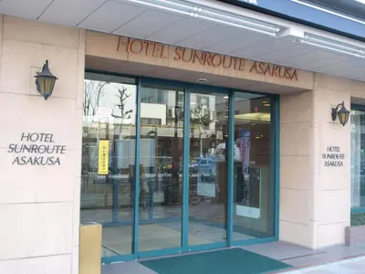 a hotel entrance with glass doors on a building at Hotel Sunroute Asakusa in Tokyo