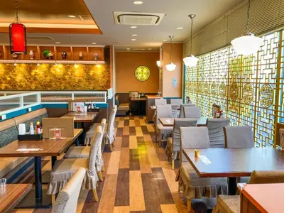a restaurant with tables and chairs and a bar at Hotel Sunroute Asakusa in Tokyo