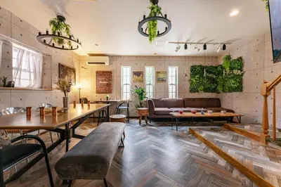 a living room with tables and a couch at Grand Piano & Shinjuku 5min walk from station in Tokyo