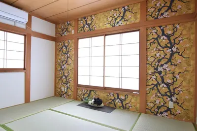 a room with a wall of windows and floral wallpaper at Sasatsuka Fleur Tachibana Hotel Apartment in Tokyo