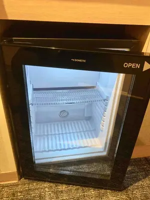 an empty refrigerator with its door open in a microwave at Dormy Inn Premium Ginza - Natural Hot Spring in Tokyo