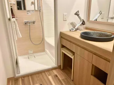 a bathroom with a sink and a shower at Dormy Inn Premium Ginza - Natural Hot Spring in Tokyo