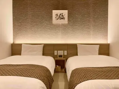 two beds in a hotel room with two beds sidx sidx sidx at Dormy Inn Premium Ginza - Natural Hot Spring in Tokyo