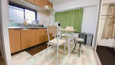 a kitchen with a table and chairs in a room at Esperanza 204\u53f7\u5ba4 in Tokyo
