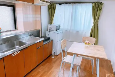 a small kitchen with a table and a sink at Esperanza 204\u53f7\u5ba4 in Tokyo