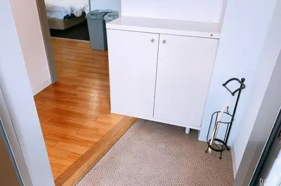 a room with white cabinets and a wooden floor at Esperanza 204\u53f7\u5ba4 in Tokyo